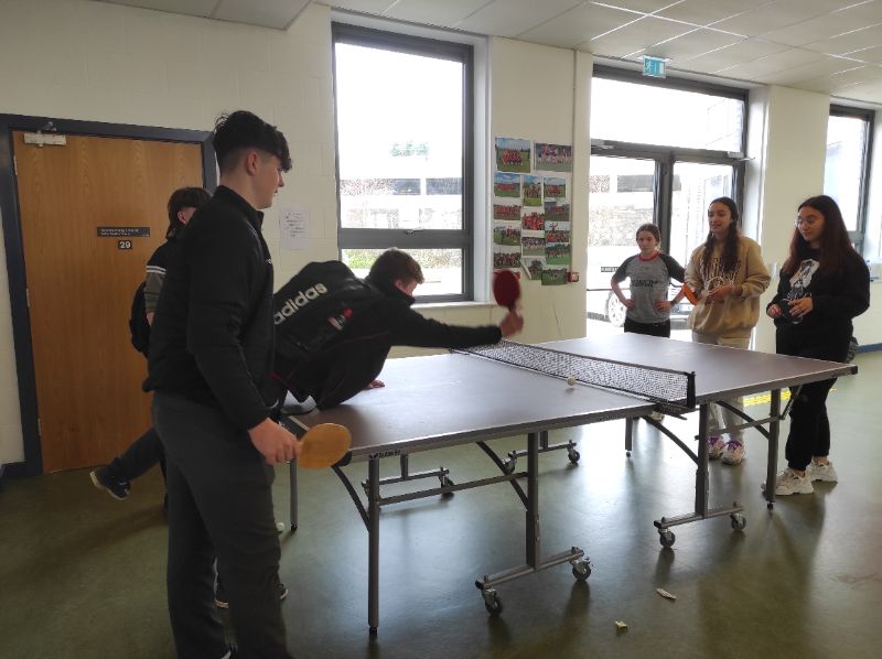 The girls playing table tennis during break